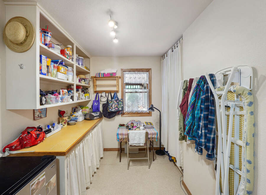 This charming utility room offers ample storage and functionality.
