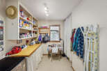 This charming utility room offers ample storage and functionality.