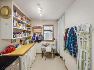 This charming utility room offers ample storage and functionality.