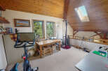This charming loft space offers a blend of functionality and style, perfect for a home office or creative studio.