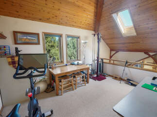 This charming loft space offers a blend of functionality and style, perfect for a home office or creative studio.