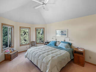 This inviting bedroom offers a serene retreat with its soft color palette and natural light.