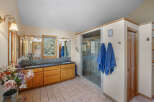 Step into a luxurious bathroom retreat! This space features a spacious walk-in shower, a double vanity with ample storage, and elegant lighting fixtures.