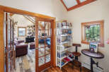 Step into this inviting home office, featuring a rustic wood floor and a stunning view.