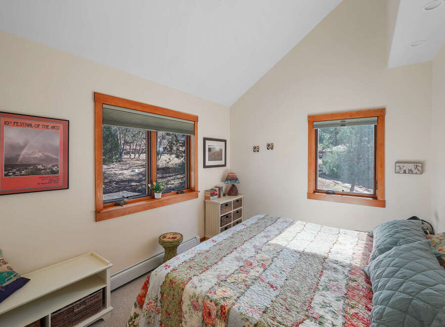 This charming bedroom offers a cozy retreat with its inviting ambiance and natural light.