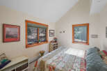 This charming bedroom offers a cozy retreat with its inviting ambiance and natural light.