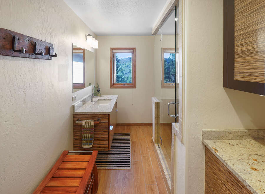 This stunning bathroom boasts a modern design with a touch of rustic charm.