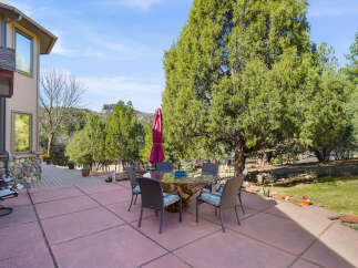 Enjoy outdoor living at its finest with this stunning property featuring a spacious patio and a beautiful dining area.
