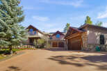 This stunning property boasts a luxurious design with a spacious driveway leading to a multi-car garage.