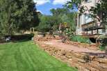 Discover the charm of this stunning property, featuring a beautifully landscaped yard and a meticulously crafted stone retaining wall.