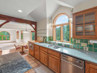Experience the charm of this spacious kitchen, featuring warm wooden cabinetry, a double sink, and a built-in microwave.