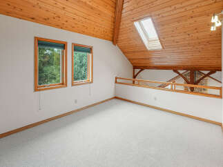 Experience the charm of this loft space, featuring a vaulted wooden ceiling and a skylight that floods the area with natural light.