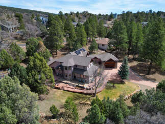 Discover this stunning multi-level home nestled among mature trees, offering privacy and natural beauty.