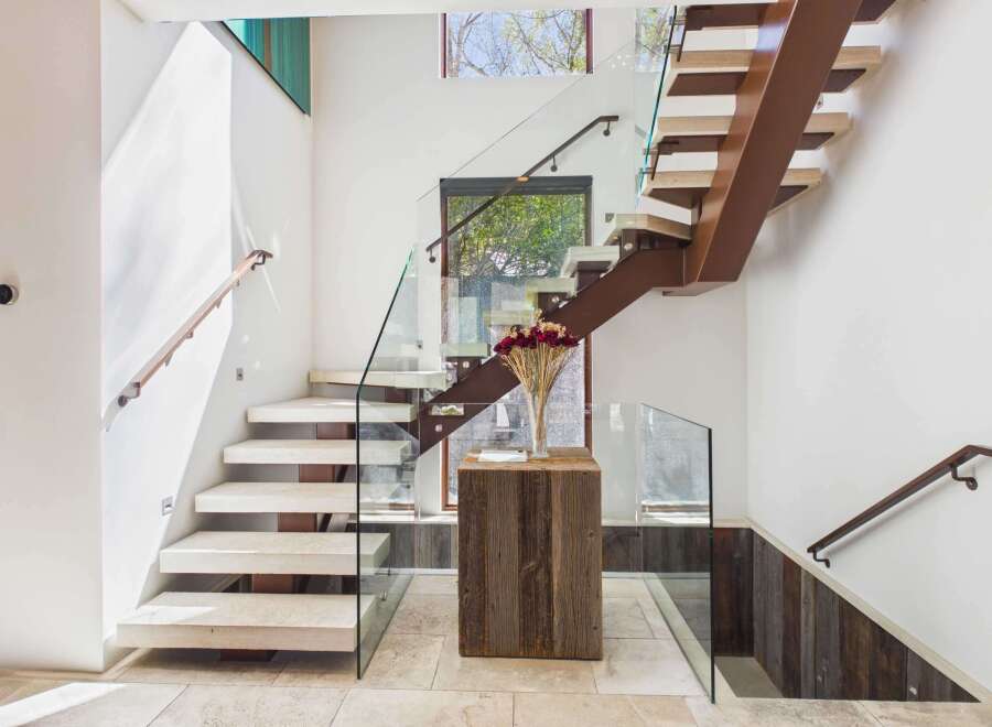 This stunning staircase showcases modern design with its floating steps and glass railings.