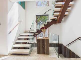 This stunning staircase showcases modern design with its floating steps and glass railings.