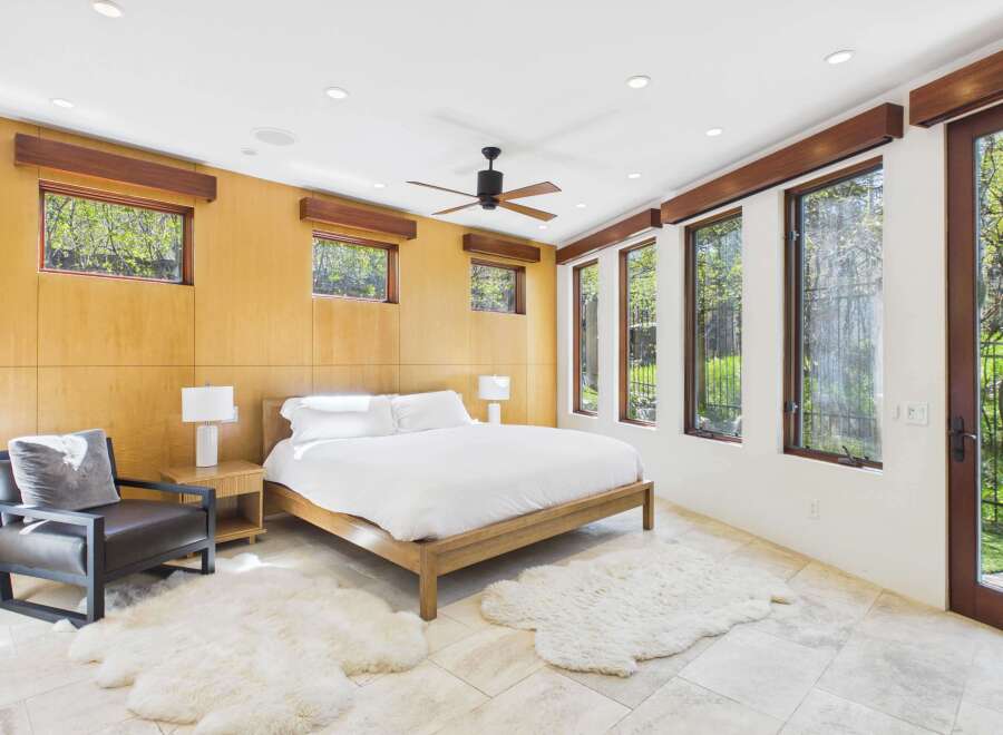 Experience luxury in this stunning bedroom featuring a modern design and natural light.
