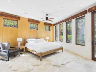 Experience luxury in this stunning bedroom featuring a modern design and natural light.