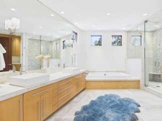 This luxurious bathroom boasts a modern design with a spacious layout.