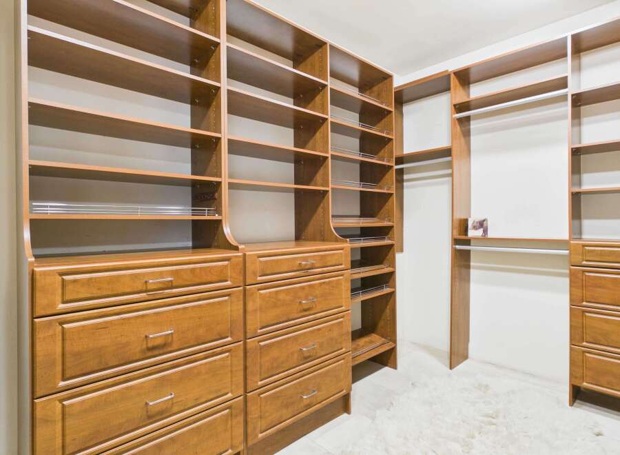 Step into luxury with this custom-built walk-in closet, designed to maximize storage and organization.