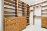 Step into luxury with this custom-built walk-in closet, designed to maximize storage and organization.