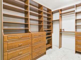 Step into luxury with this custom-built walk-in closet, designed to maximize storage and organization.