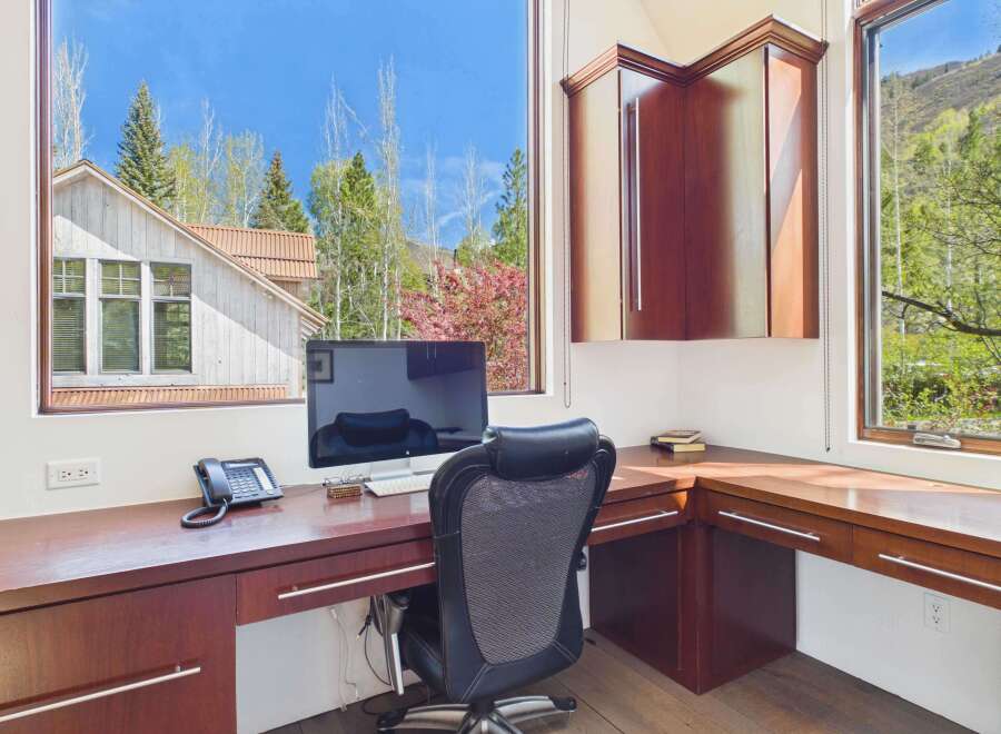This stunning home office boasts a bright and airy atmosphere, perfect for productivity.