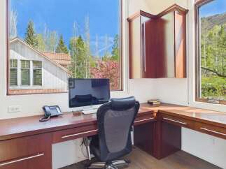 This stunning home office boasts a bright and airy atmosphere, perfect for productivity.