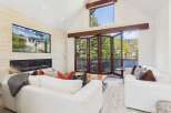 Experience luxury living in this stunning property featuring a modern fireplace and a large screen TV.