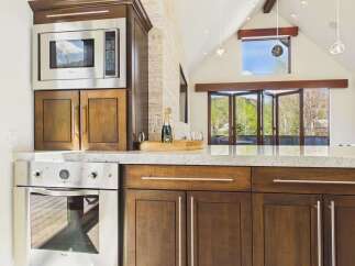 This stunning kitchen boasts modern appliances and elegant cabinetry, perfect for culinary enthusiasts.