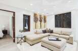 This stunning living room boasts a modern design with a comfortable sectional sofa and a stylish ottoman.