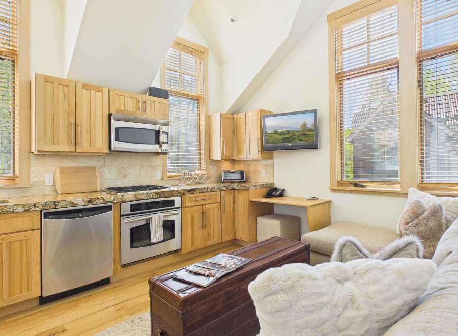 This stunning kitchen boasts a modern design with stainless steel appliances and beautiful wooden cabinetry.
