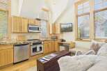 This stunning kitchen boasts a modern design with stainless steel appliances and beautiful wooden cabinetry.