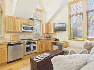 This stunning kitchen boasts a modern design with stainless steel appliances and beautiful wooden cabinetry.