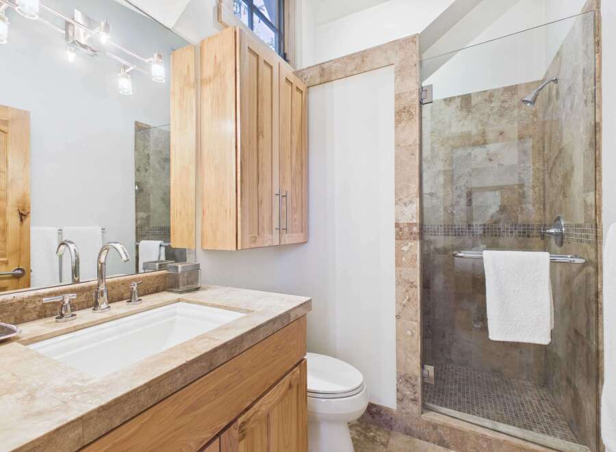 Step into luxury with this stunning bathroom! Featuring a sleek glass shower, elegant vanity, and ample storage, this space is designed for both style and functionality.