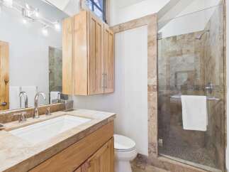 Step into luxury with this stunning bathroom! Featuring a sleek glass shower, elegant vanity, and ample storage, this space is designed for both style and functionality.