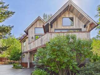 Experience rustic charm in this unique wooden home, nestled amidst lush greenery.