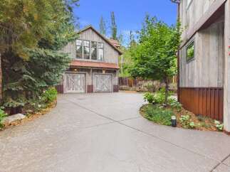 Discover this charming rustic property featuring a spacious two-car garage with a loft, perfect for storage or a workshop.
