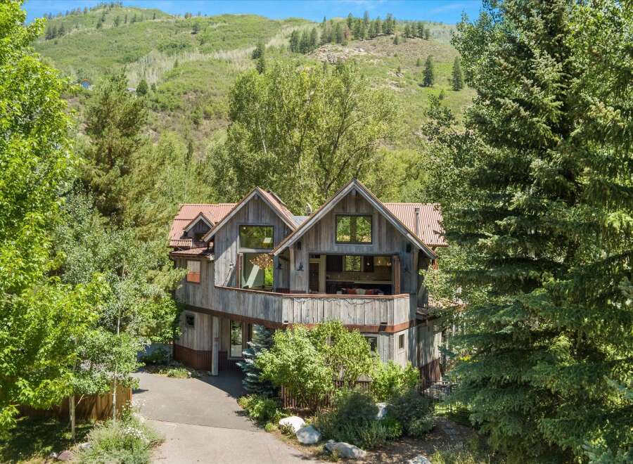 Nestled amidst lush greenery and rolling hills, this rustic mountain home offers a serene escape.