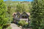 Nestled amidst lush greenery and rolling hills, this rustic mountain home offers a serene escape.
