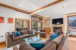 Experience luxury living in this stunning property, featuring a spacious living room with a cozy fireplace and a modern entertainment setup.