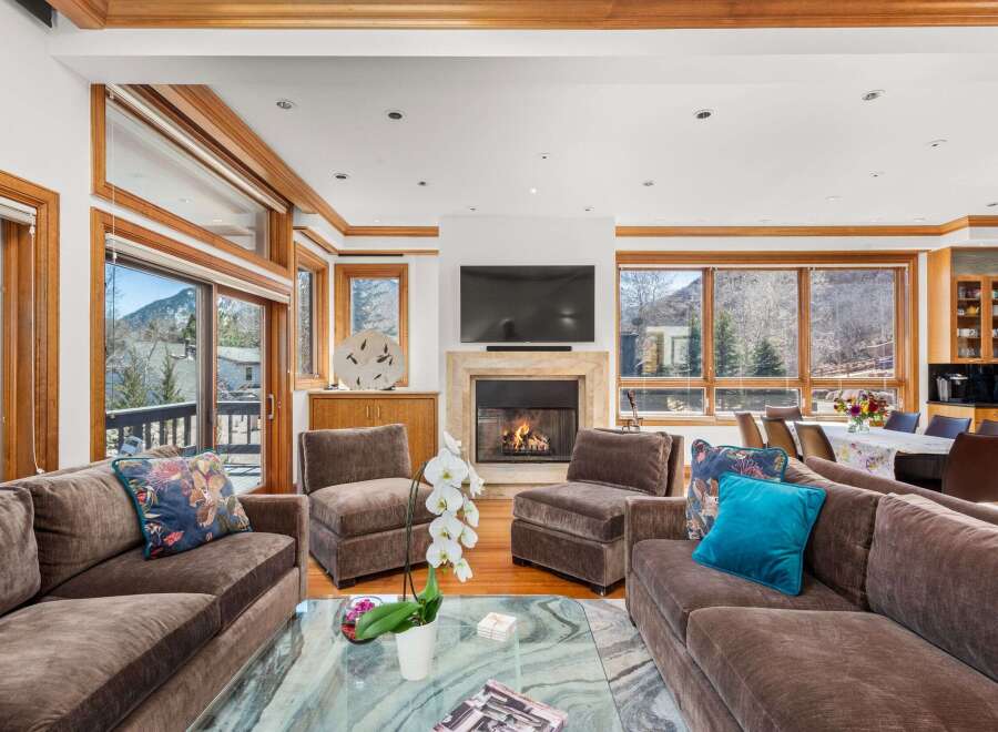 Experience luxury living in this stunning property, featuring a spacious living room with a cozy fireplace and ample seating.
