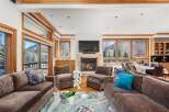 Experience luxury living in this stunning property, featuring a spacious living room with a cozy fireplace and ample seating.