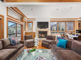 Experience luxury living in this stunning property, featuring a spacious living room with a cozy fireplace and ample seating.