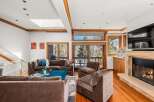 Experience luxury living in this stunning property featuring a spacious living room with a cozy fireplace and ample seating.
