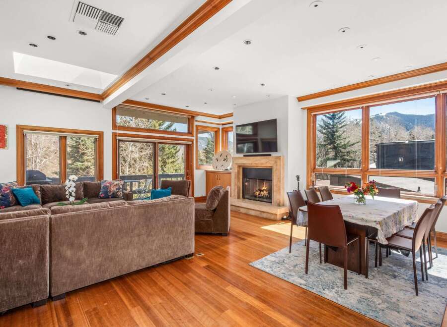 Experience luxury living in this stunning property, featuring a cozy fireplace and a spacious living area.