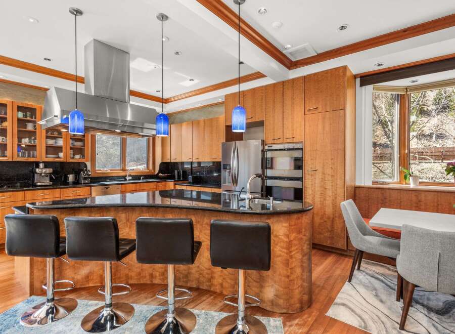 This stunning kitchen boasts a modern design with sleek cabinetry and a spacious island.