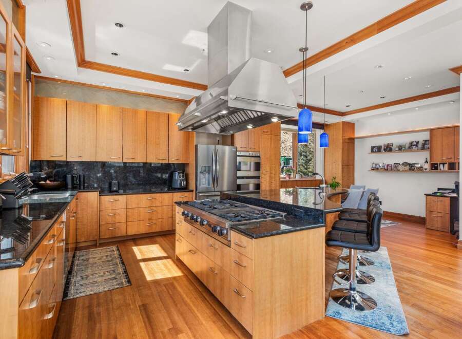 This stunning kitchen boasts a modern design with high-end appliances and custom cabinetry.
