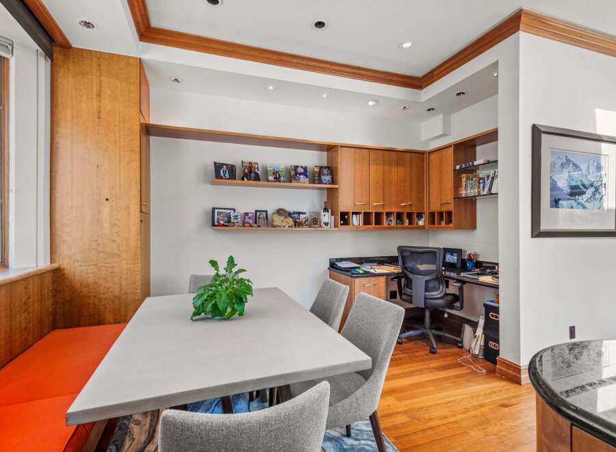 This stunning home office features custom cabinetry and a built-in desk, perfect for productivity.