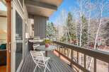 Enjoy breathtaking views from this stunning balcony! This outdoor space features a grill, perfect for entertaining, and a cozy table with chairs.