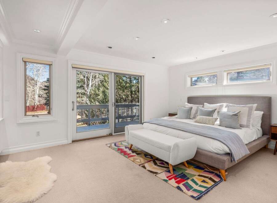Step into a serene bedroom retreat, bathed in natural light and offering stunning views.